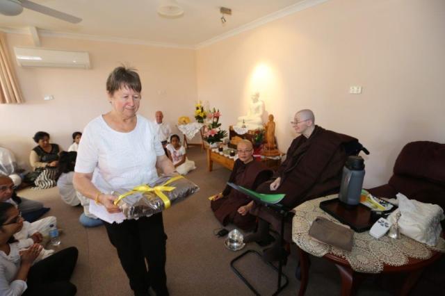 The cloth offerings was handed around the participants to join in the merits of offering. Photo by Zor.